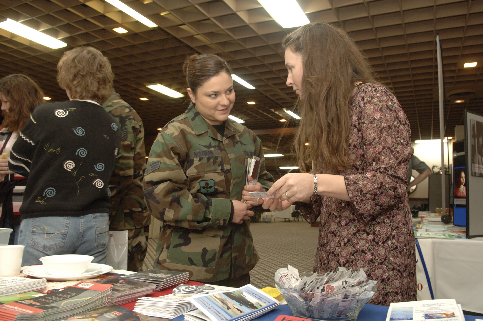 Senior Airman Tara Norman, 336th Training Support Squadron, accepts base information from Melissa Still of the Airman and Family Readiness Center at the Right Start seminar Jan. 12. Airman Norman arrived at Fairchild Nov. 4 from Kirtland Air Force Base, N.M.