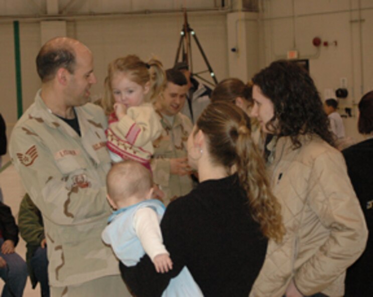 NIAGARA FALLS AIR RESERVE STATION, N.Y.- Staff Sgt. Simon Lissner, Medical Technican with the 914th AeroMedical Staging Squadron holds his daughter one last time before he departs for Iraq.   Lissner will  deploy in support of Operation Iraqi Freedom where he will be helping treat wounded soliders and civilians.  (U.S. Air Force photo/Tech. Sgt. Kevin Nichols)