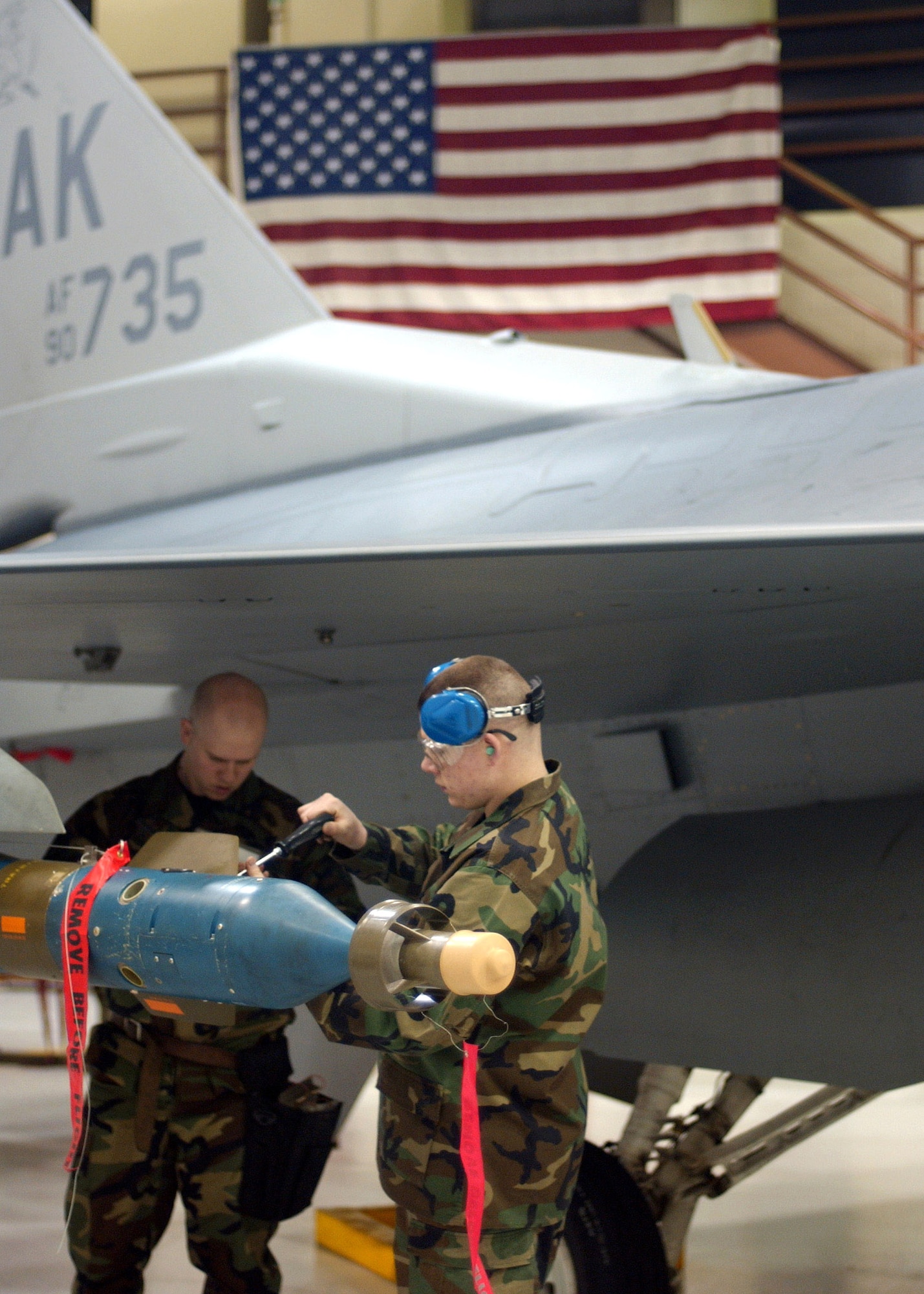 Staff Sgt. Aaron Slay and Senior Airman Michael Lee tighten down bolts to an air-to-ground missile on an F-16 Fighting Falcon for the Weapons Standardization Load Crew of the Year Competition Jan. 11 at Eielson Air Force Base, Alaska. The competition evaluates technical proficiency, safety procedures and overall time. Both are assigned to the 18th Aircraft Maintenance Unit. The 18th AMU's overall time was 56 minutes and 37 seconds. (U.S. Air Force photo/Airman Jonathan Snyder) 
