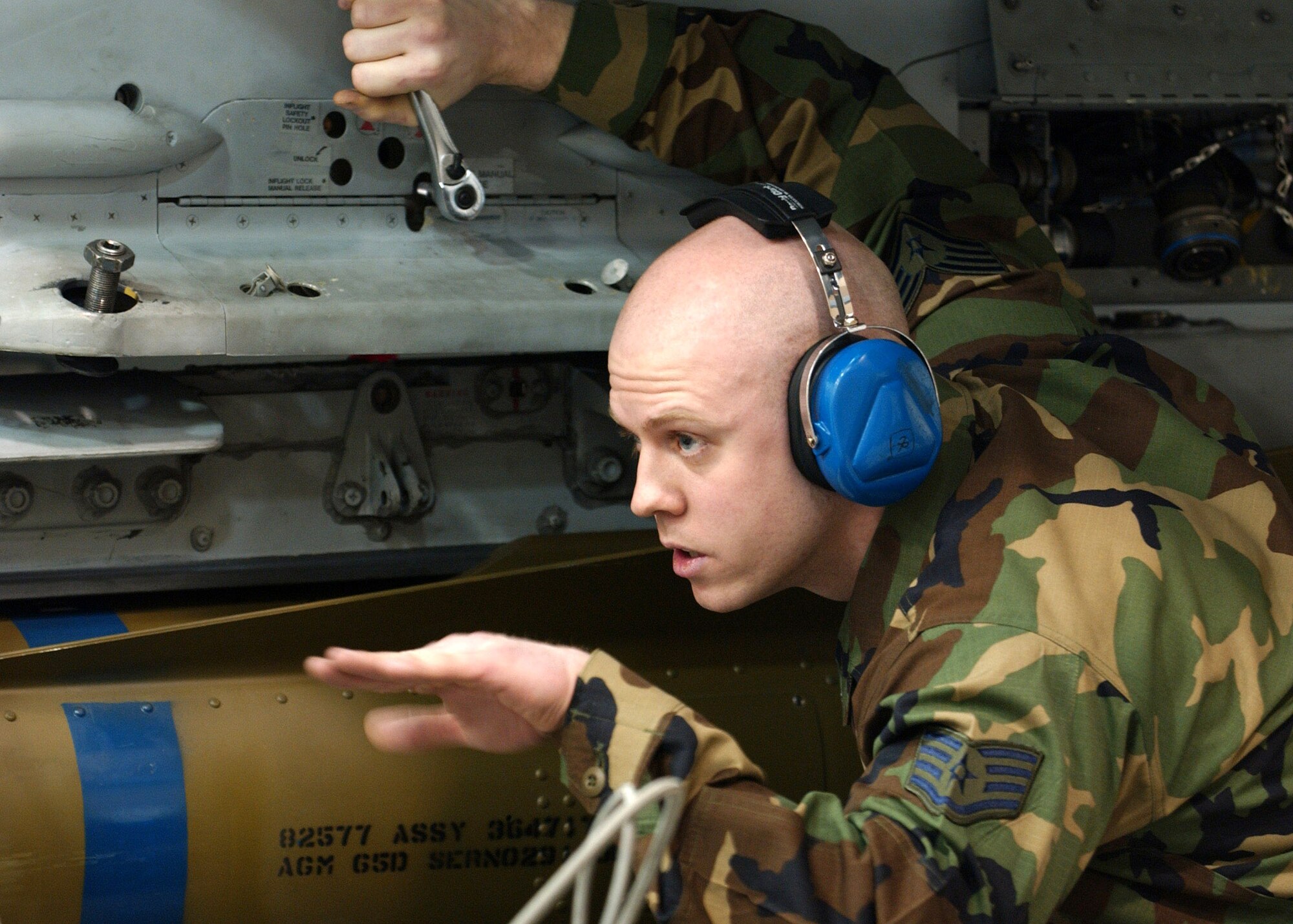 Staff Sgt. Aaron Slay motions to position an air-to-ground missile to be loaded onto an F-16 Fighting Falcon for the Weapons Standardization Load Crew of the Year Competition Jan. 11 at Eielson Air Force Base, Alaska. The competition evaluates technical proficiency, safety procedures and overall time. Sergeant Slay is assigned to the 18th Aircraft Maintenance Unit. The 18th AMU's overall time was 56 minutes and 37 seconds. (U.S. Air Force photo/Airman Jonathan Snyder) 