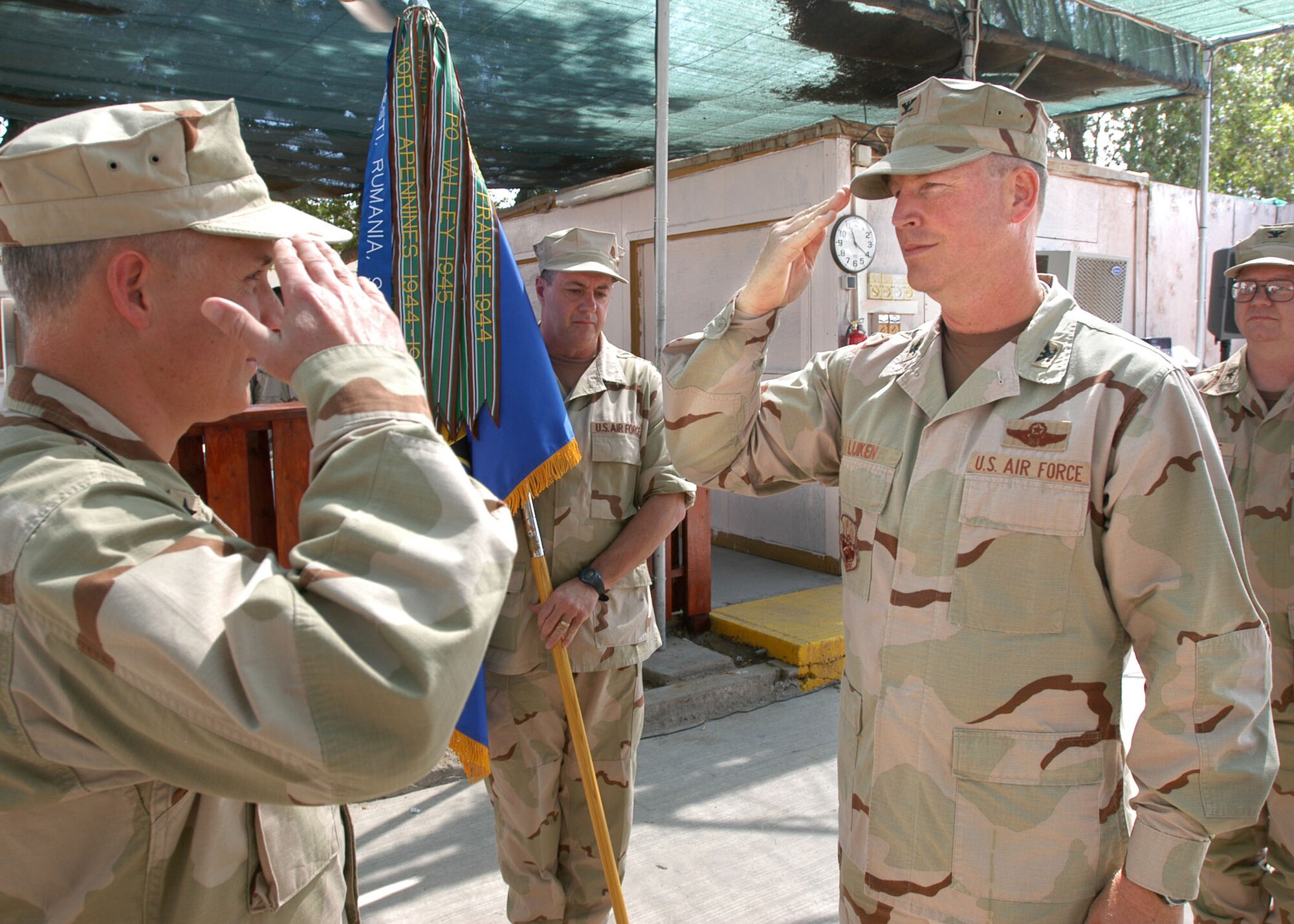 Camp Lemonier, Djibouti - Col. Marc Luiken (right), outgoing commander for the 449th Air Expeditionary Group, relinquishes command during a change of command ceremony held at Camp Lemonier, Djibouti Jan. 11. The colonel, who is the 325th Mission Support Group commander here, was deployed to the Horn of Africa for five months. 