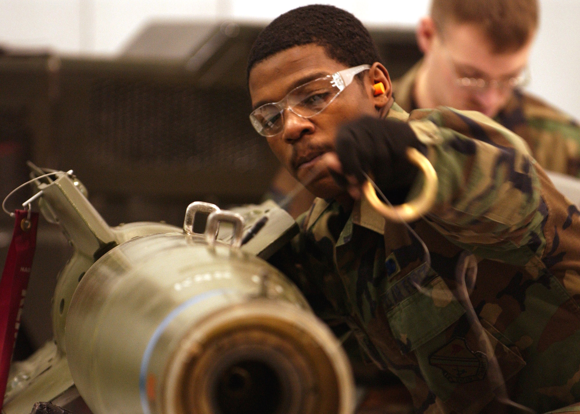Senior Airman Keitric King installs the fuse intiator that arms the guided bomb unit 12 that will be loaded onto an A-10 Thunderbolt II for the Weapons Standardization Load Crew of the Year Competition Jan. 11 at Eielson Air Force Base, Alaska. The competition evaluates technical proficiency, safety procedures and overall time. The 355th AMU's overall time was 50 minutes and 17 seconds. Airman King is assigned to the 355th AMU. (U.S. Air Force photo/Airman Jonathan Snyder) 
