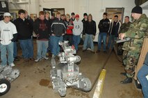 MINOT AIR FORCE BASE, N.D. -- Staff Sgt. Josh Singleton, 5th Civil Engineer Squadron Explosive Ordnance Disposal, introduces "Andros," an EOD robot, to students from Mandan High School, Bismarck, N.D., during a base tour here Jan. 17. EOD members can maneuver the robot from a remote screen, essentially making the robot the best tool to reach explosive areas too dangerous for military members. (U.S. Air Force photo by A1C Christopher Boitz) 