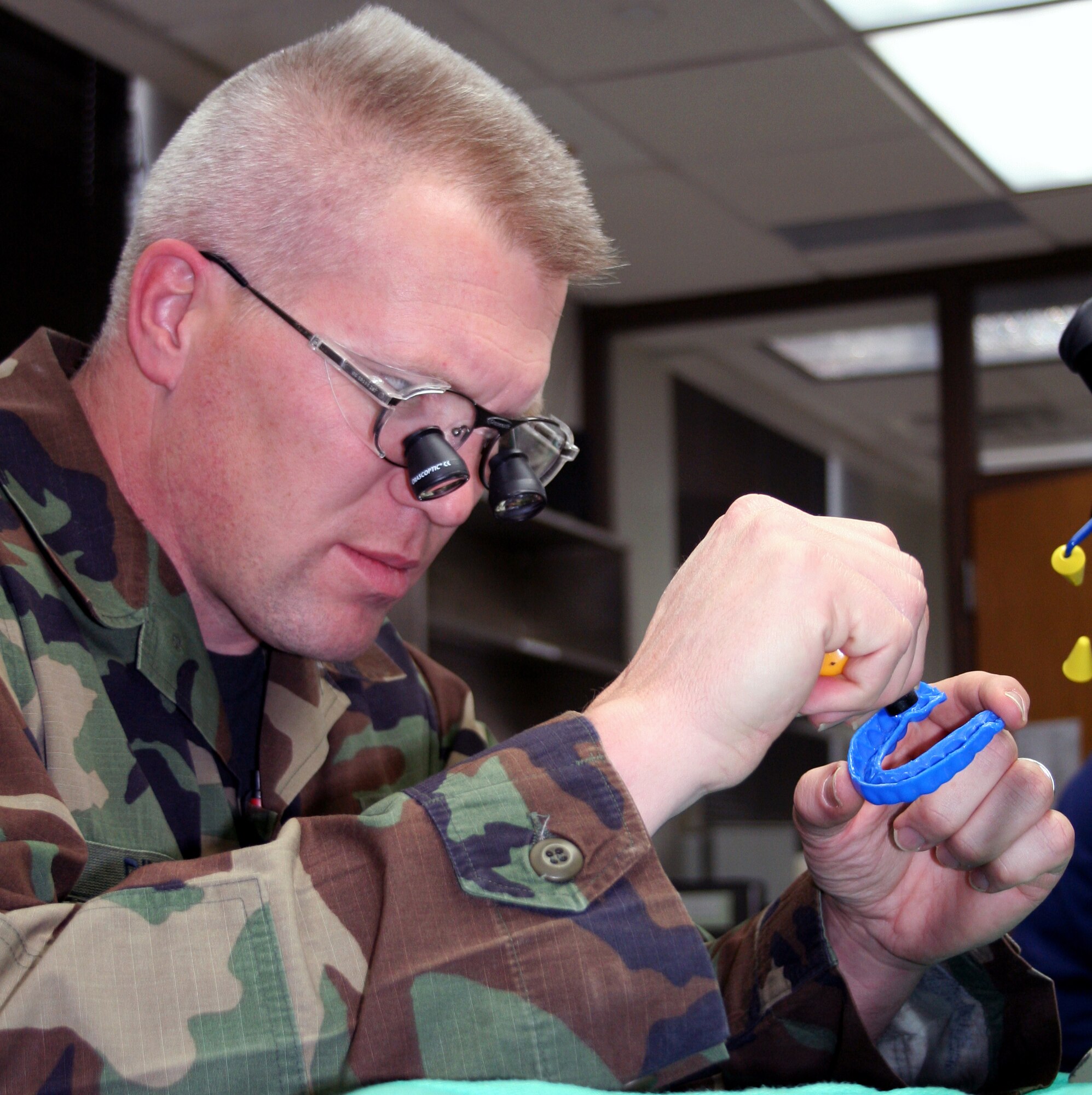 Mouthguards are a preventive measure often overlooked when people prepare to play a sport. But, the 82nd Dental Clinic can help prevent tooth and mouth injuries with custom-made mouthguards. Here, Tech. Sgt. Michael Rinnels smooths the edge of a custom-made mouthguard with a butane torch to provide a more comfortable fit for the wearer. (U.S. Air Force photo/Adrian McCandless)