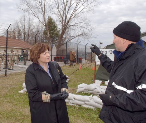 66th Air Base Wing Honorary Commander Christine Schuster, Emerson Hospital president and chief executive officer, toured 66 ABW facilities on Jan. 12. Ms. Schuster speaks with Brent Nagele, 66th Mission Support Group Training and Emergency Response, at Camp Patriot, Hanscom’s simulated deployment camp. U.S. Air Force photo by Jan Abate
