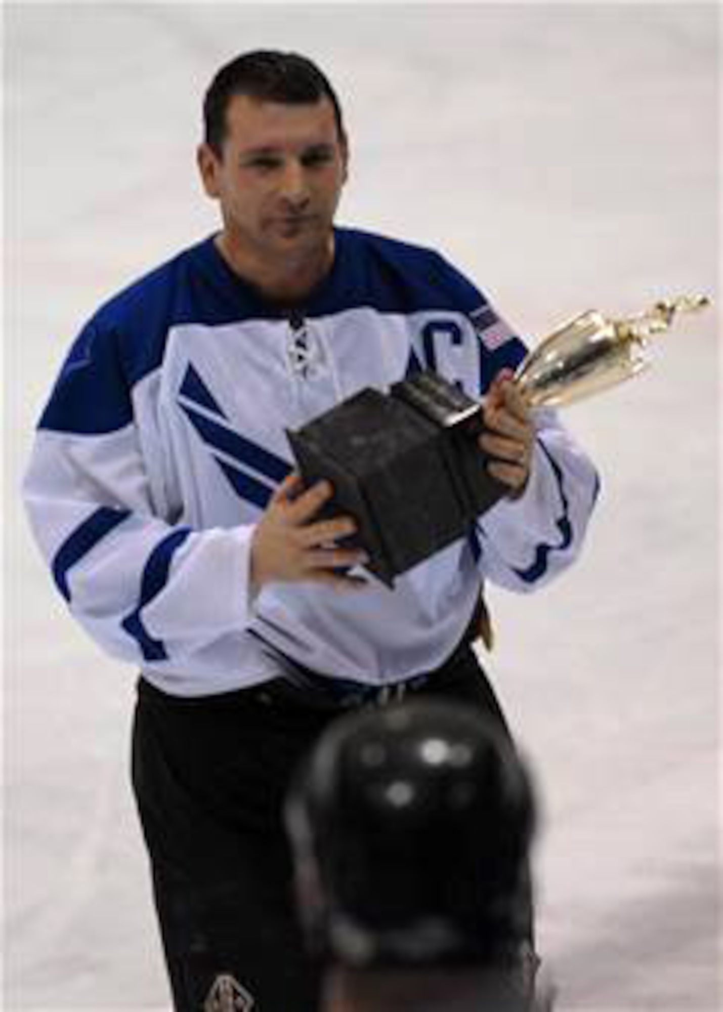 Senior Master Sgt. Dan Morin holds the trophy for the Commander's Cup Hockey Game Jan. 13 at the Big Dipper Ice Arena in Fairbanks, Alaska. Eielson Icemen faced off against the Fort Wainwright Grizzlies in the 11th Annual Interior Alaska Armed Forces Ice Hockey Commander's Cup Game. Eielson Icemen went on to win the game 8 to 6. Sergeant Morin is assigned to the 354 Fighter Wing at Eielson Air Force Base, Alaska. (U.S. Air Force photo/Airman Jonathan Snyder)
