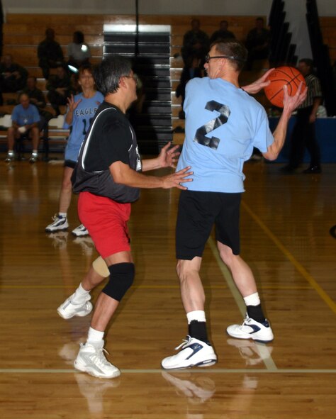 Lansen Conley, 82nd Training Wing vice commander, attempts to get past Enrique Henson, from the 882nd Training Support Squadron, during the Chiefs vs. Eagles game Jan. 12 at the Pitsenbarger Fitness Center. (U.S. Air Force photo/Airman 1st Class Jacob Corbin.)