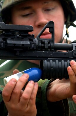 Senior Airman Bryan Ables, 31st Security Forces Squadron security response team member, loads a 40mm practice round on an M-203 grenade launcher attached to an M-4 rifle. 
Fifteen security forces Airmen were combat arms trained for deployment and duty qualifications Jan. 11 at the Malnisio range. 
The 31st SFS trains at the Malinisio range, which is north of Aviano, every other month for different weapons qualifications. 
