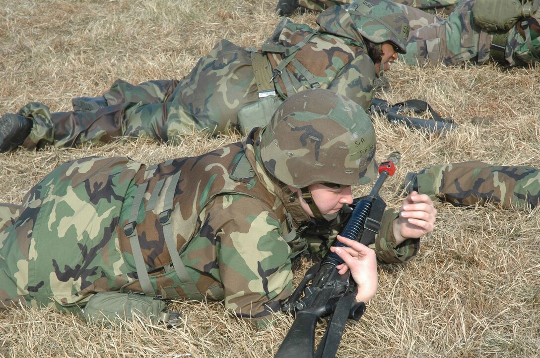 OSAN AIR BASE, Republic of Korea --  Getting their faces in the dirt, Airman practice low-crawling during the Installation Arming and Response course. In this course, Airmen E-1 through E-6 will be taught how to defend against, deny and delay opposing forces. The January and future exercises will use the method to provide defense of the base. (U.S. Air Force photo by 2nd Lt. Kim Schaerdel)