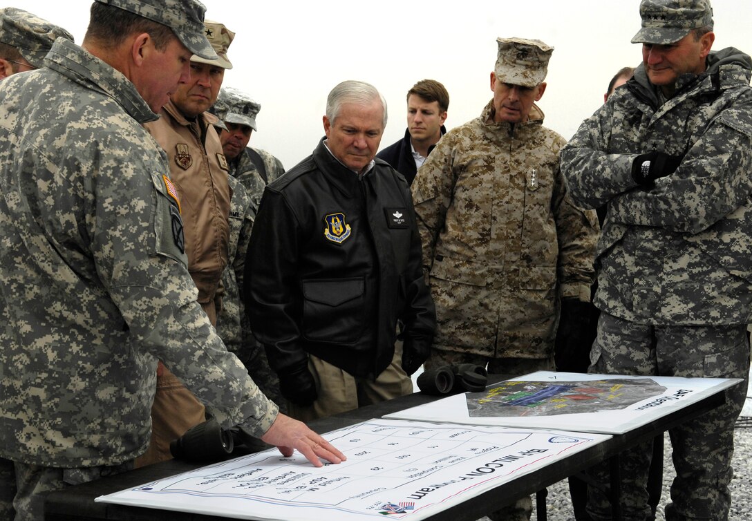 U.S. Army Maj. Gen. Benjamin Freakley talks about the status of Bagram Air Field to Defense Secretary Robert Gates, center, and Chairman of the Joint Chiefs of Staff U.S. Marine Gen. Peter Pace, second from right, while Maj. Gen. Karl Eikenberry looks on, at Bagram Air Field, Afghanistan, Jan. 17, 2007.