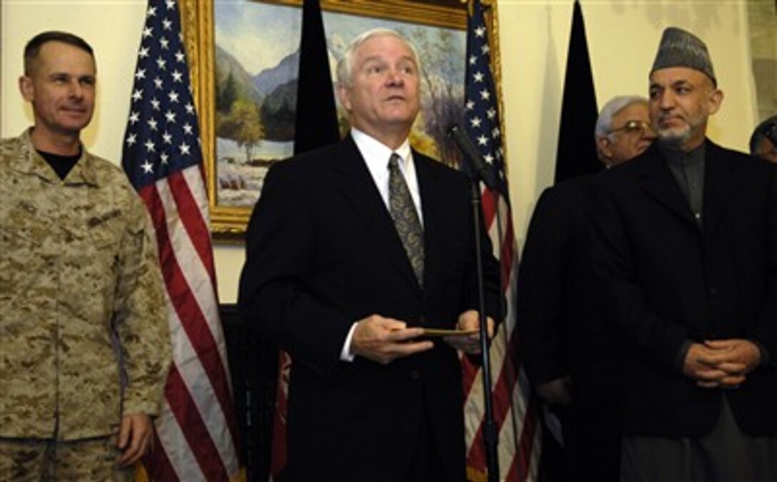 Secretary of Defense Robert M. Gates (center) conducts a press conference with President of Afghanistan Hamid Karzai (right) and Chairman of the Joint Chiefs of Staff Gen. Peter Pace, U.S. Marine Corps, at the presidential palace in Kabul, Afghanistan, on Jan. 16, 2007.  Gates and Pace are in Afghanistan to meet with Karzai, senior military leaders and the deployed troops.  