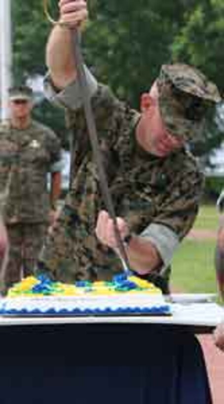 Brig. Gen. David H. Berger, assistant division commander, 2nd Marine Division, cuts the cake during a ceremony for the 109th Navy Hospital Corps birthday here, June 18. The first two pieces of the cake are given to the oldest and youngest corpsman at the ceremony.