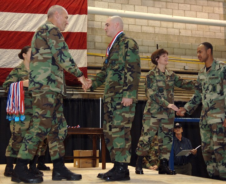 From left, Col. Tom Schluckebier, 66th Air Base Wing commander, and Chief Master Sgt. Lisa Sirois, 66 ABW and Electronic Systems Center command chief master sergeant, congratulate returned deployed Airmen during the Heroes' Homecoming Jan. 19 at Hanscom Air Force Base, Mass. (U.S. Air Force photo/Jan Abate)