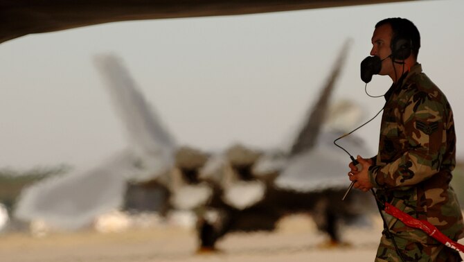 Senior Airman Joseph Vanord, a dedicated crew chief with the 94th Fighter Squadron at Langley Air Force Base in Virginia, begins shut downs procedures on a F-22A Raptor piloted by 1st Fighter Wing Commander Brig. Gen. Burton Field on Jan. 19, 2007.   (U.S. Air Force photo/Staff Sgt. Samuel Rogers) 