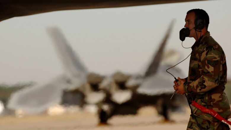 Senior Airman Joseph Vanord, a dedicated crew chief with the 94th Fighter Squadron at Langley Air Force Base in Virginia, begins shut downs procedures on a F-22A Raptor piloted by 1st Fighter Wing Commander Brig. Gen. Burton Field on Jan. 19, 2007. General Field's delivery of the 40th F-22A Raptor from the factory at Lockheed Martin in Marietta, Ga., to the 1st Fighter Wing at Langley AFB marks the completion of delivery from factory to the installation. (USAF Photo by Staff Sgt Samuel Rogers)