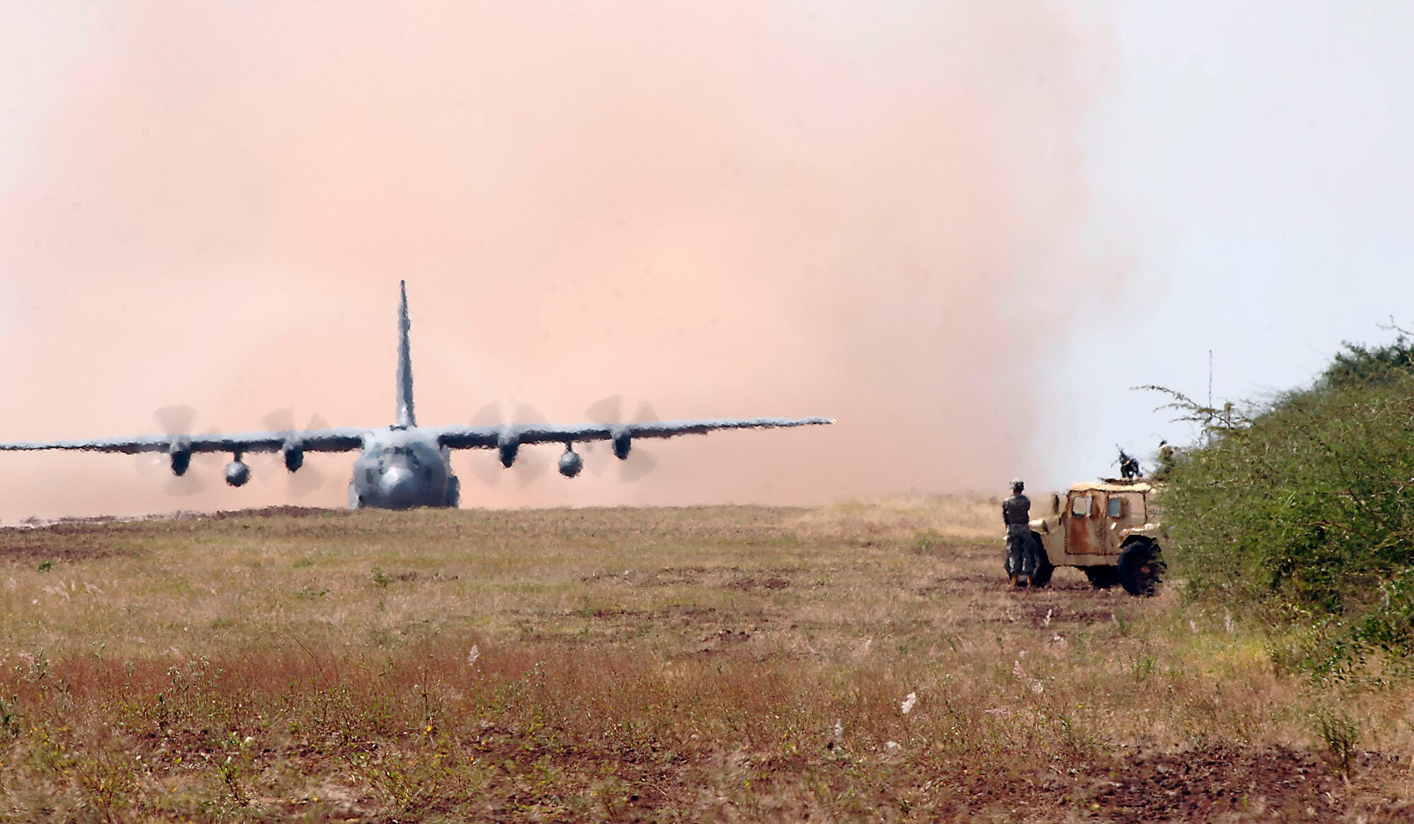 A C-130 Hercules lands on a 4,500-foot dirt landing strip in southern Ethiopia. The runway, lined with lava rock native to the area, is the only means of delivering passengers and cargo to a U.S. contingency operating base in the remote village of Bilate, Ethiopia where Guam Army National Guardsman, Airmen and Sailors work to provide military training to Ethiopian forces in the region. The C-130 and crew are deployed to the Horn of Africa from Elmendorf Air Force Base, Alaska. (U.S. Air Force photo/Master Sgt. Scott Wagers)