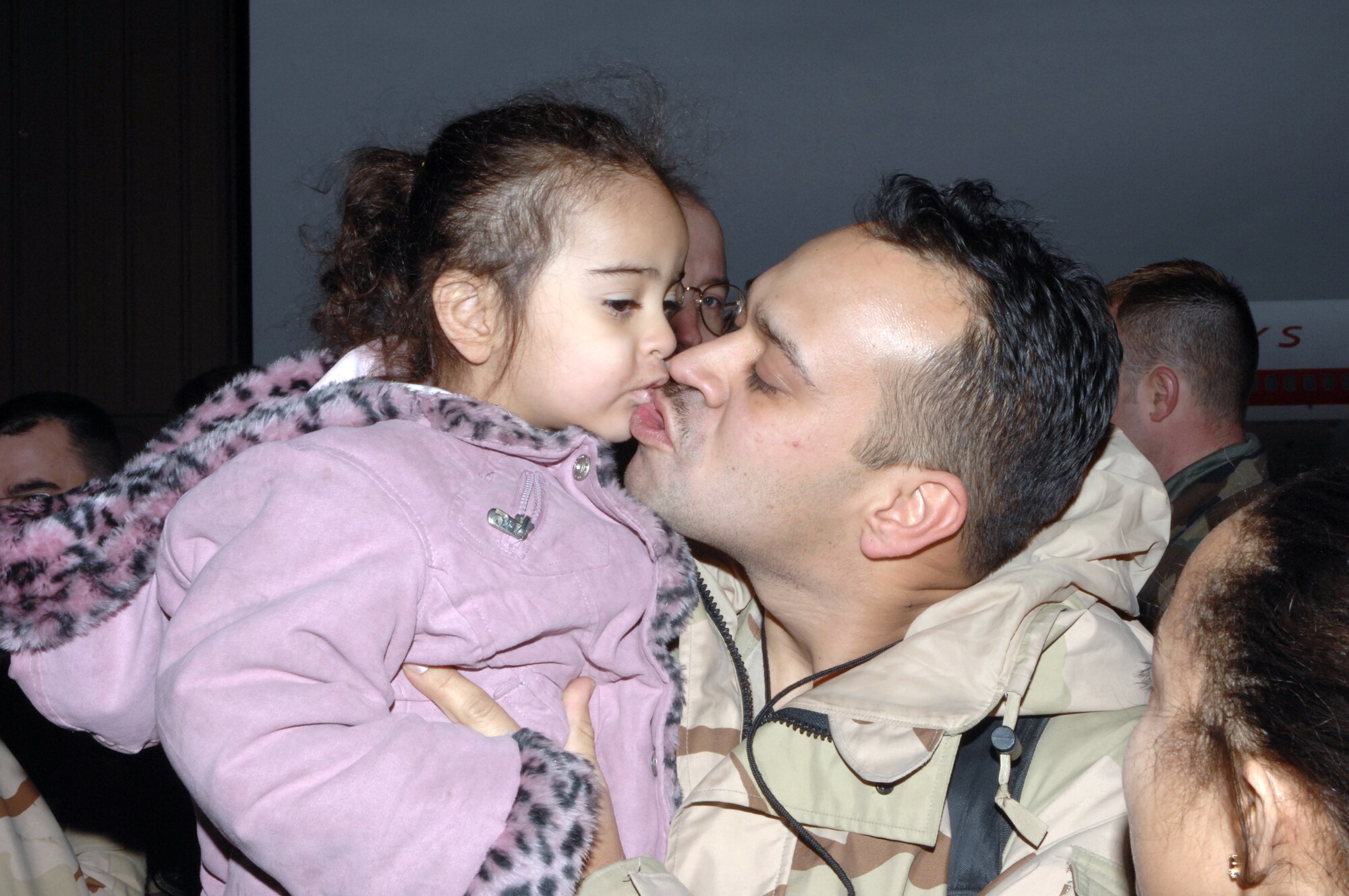 Staff Sgt. Erving Camacho shares a kiss with his daughter, Ryoko, Jan. 18 at Cannon Air Force Base, N.M. Sergeant Camacho and other Airman from Cannon AFB returned after serving in Iraq as part of the Air Expeditionary Force 3 and 4 rotation. Sergeant Camacho is assigned to the 524th Aircraft Maintenance Unit. (U.S. Air Force photo/Airman 1st Class Randi Flaugh)