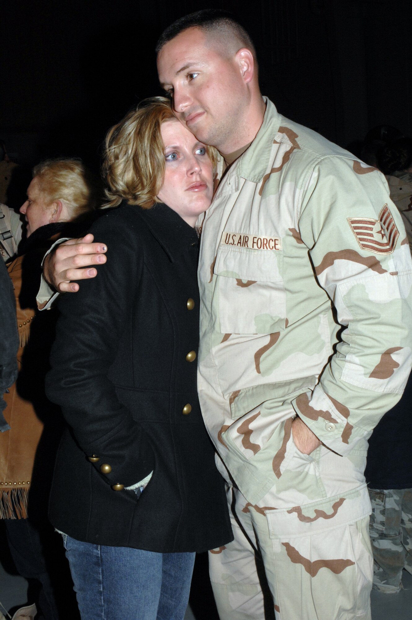 Tech. Sgt. Lee Robbins takes a moment with wife, Staff Sgt. Amber Robbins, at a homecoming ceremony Jan. 18 at Cannon Air Force Base, N.M. He and other Airmen from Cannon Air Force Base, N.M. were serving in Iraq as part of the Air Expeditionary Force 3 and 4 rotation. He is assigned to the 27th Aircraft Maintenance Squadron and she is assigned to the 27th Mission Support Squadron. (U.S. Air Force photo/Airman First Class Randi Flaugh) 
