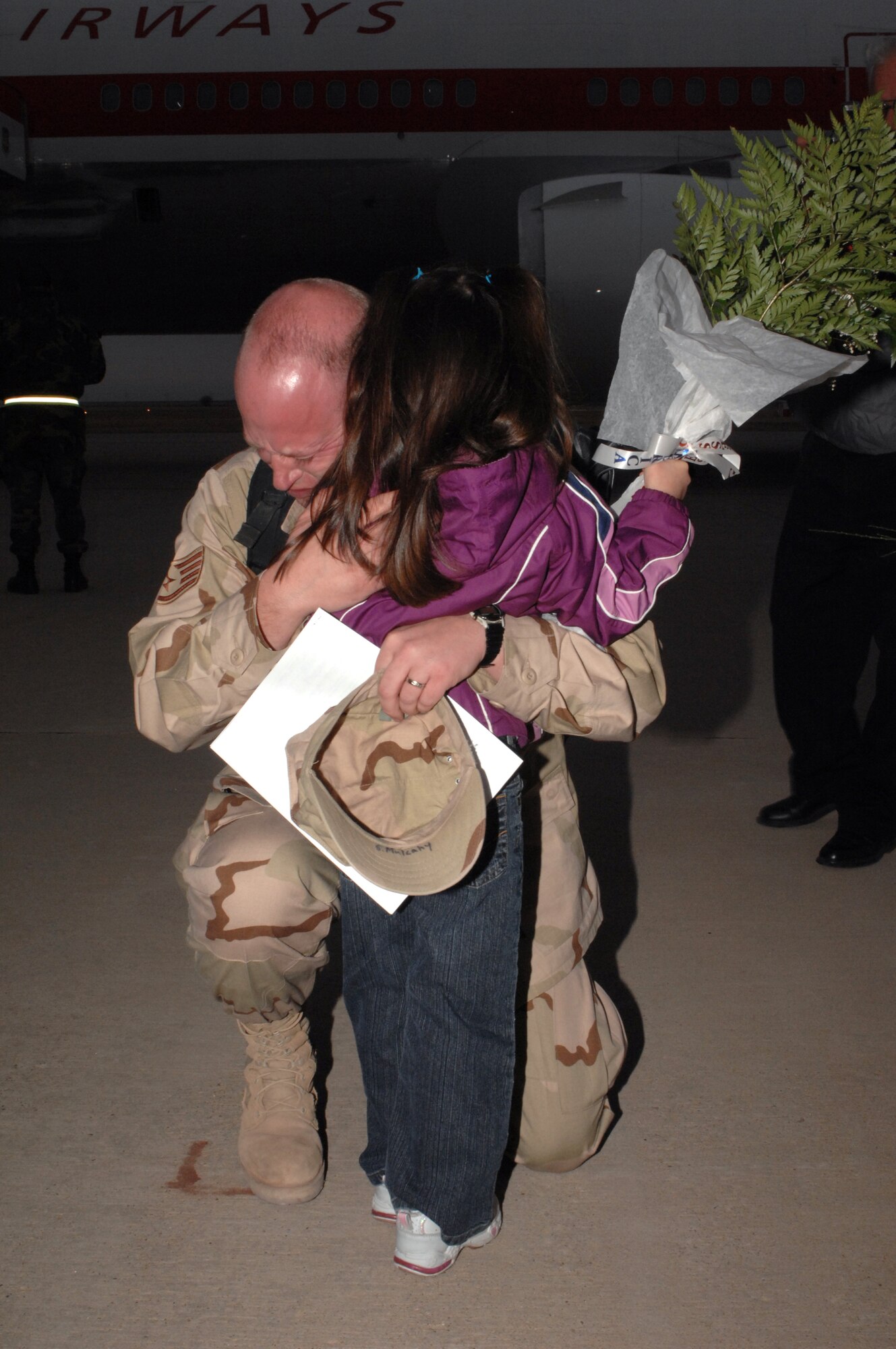 Staff Sgt. Sean Mulcahy embraces his daughter, Sabrina, after returning home from a deployment in Iraq Jan. 18 at Cannon Air Force Base, N.M. Sergeant Mulcahy and other Airmen from Cannon AFB returned to a crowd of family and friends. He is assigned to the 27th Aircraft Maintenance Squadron. (U.S. Air Force photo/Airman First Class Randi Flaugh)

