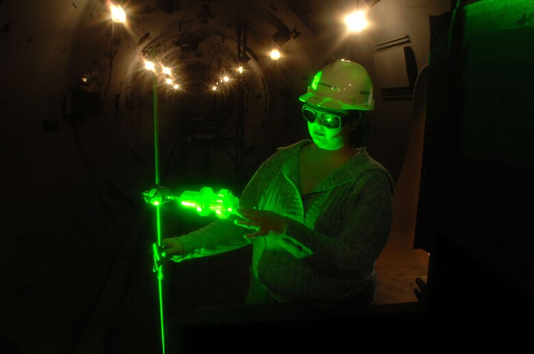 Katie Stephens aligns a projectile with a laser at the Arnold Engineering Development Center's large Hypervelocity Ballistic Range G facility at Arnold Air Force Base, Tenn. The laser assesses the condition of a projectile during a specific stage of flight. The Range G launcher is the largest, two-stage, light-gas gun system in the United States that can launch extremely high-fidelity missile simulations at hypervelocity speeds. Ms. Stephens is an optical diagnostics group engineer with Aerospace Testing Alliance's technology and analysis branch. (U.S. Air Force photo/Rick Goodfriend) 
