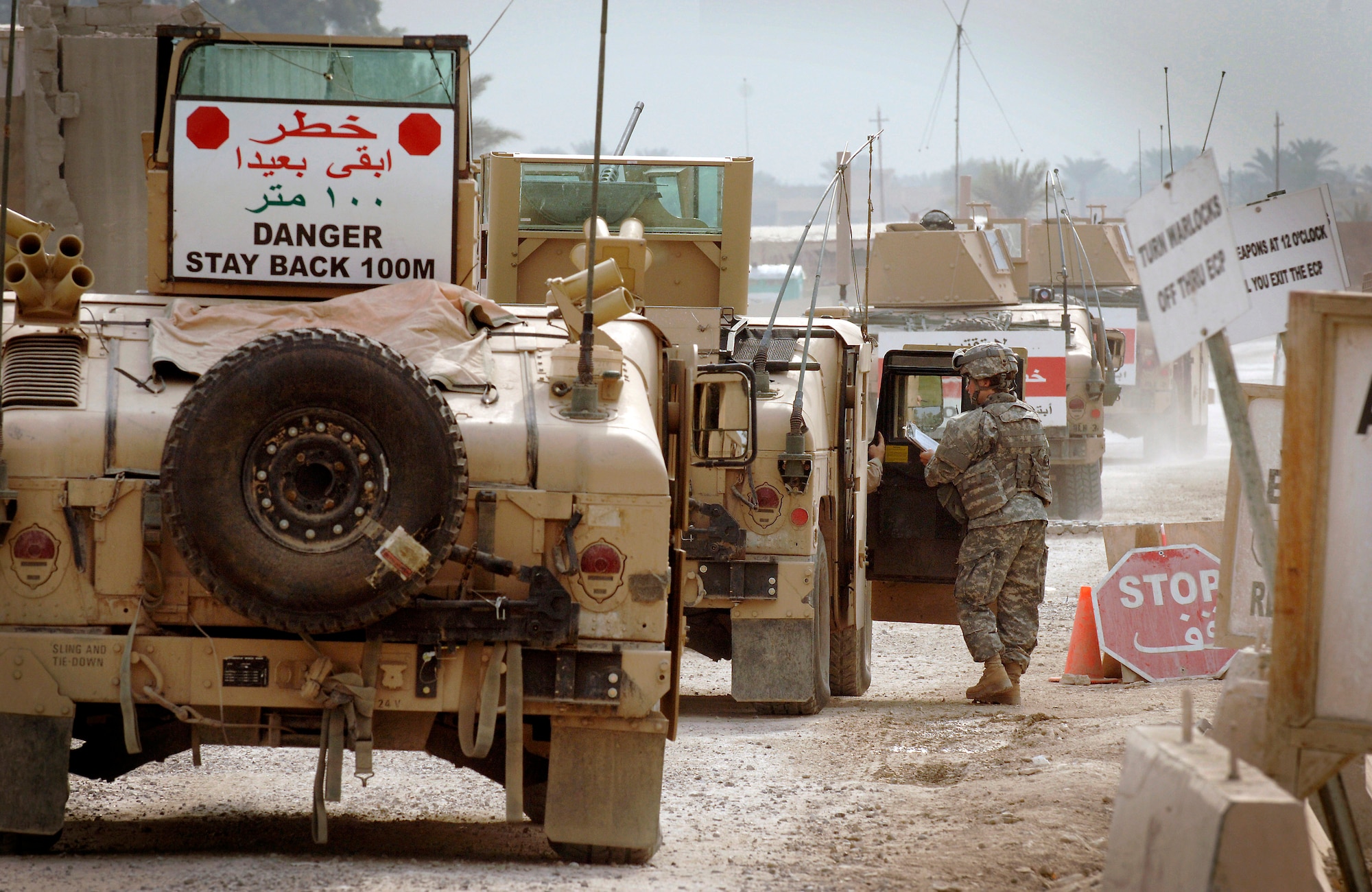 Prior to departing Camp Liberty for an eight-hour patrol through Baghdad, Staff Sgt. Justin Geers (inside vehicle) relays the number of people and vehicles in his patrol to Army Sgt. Bronwen Thompson. Once outside the camp, communication assets are critical. Sergeant Geers is the Air Force security forces squad leader. Sergeant Geers and his 12-member squad are assigned to the 732nd Expeditionary Mission Support Group's Detachment 7. (U.S. Air Force photo/Master Sgt. Scott Wagers)