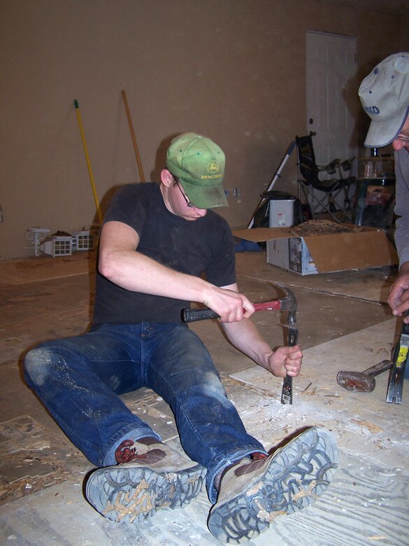 Airman 1st Class Derek Bartholic works on restoring sub-flooring in a house in Bay St. Louis, Miss. The home was damaged by Hurricane Katrina more than a year ago. Airman Bartholic is a maintenance specialist assigned to the 354th Aircraft Maintenance Squadron from Eielson Air Force Base, Alaska. He was one of five Airmen who travelled from Eielson AFB to the Gulf coast to repair Hurricane Katrina-damaged homes. (U.S. Air Force photo/Senior Airman Anthony Nelson)
