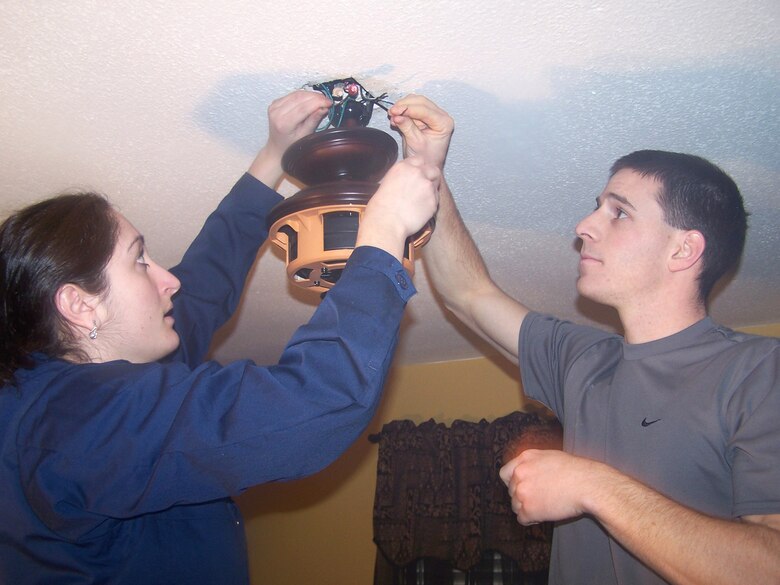 Senior Airman Christy Cadle and Airman 1st Class Troy Sergeant work on electric wiring for a light fixture in a home in Bay St. Louis, Miss. The home was damaged by Hurricane Katrina more than a year ago. Airman Cadle is assigned to the 354th Aircraft Maintenance Squadron and Airman Sergeant is from the 354th Civil Engineer Squadron. Both are from Eielson Air Force Base, Alaska. (U.S. Air Force photo/Senior Airman Anthony Nelson)
