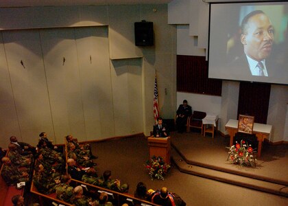 As a photo of the late civil rights leader is projected on the altar behind him, Brig. Gen. Darrell Jones, then the commander of the 37th Training Wing at Lackland Air Force Base, Texas, welcomes members of Team Lackland to a commemorative service Jan. 11, 2007, at Freedom Chapel honoring Dr. Martin Luther King Jr. Guest speaker for the service was a longtime Lackland choir director, Bradley Scott, Ph.D., senior education associate for the Intercultural Development Research Association. (USAF photo by Alan Boedeker)                               