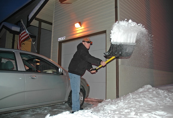 Staff Sgt. Phillip Bridges shovels the driveway of his new home Jan. 17. Thanks to a total basewide effort at Eielson Air Force Base, Alaska, Sergeant Phillips' family was one of 241 successfully relocated from the on-base Sprucewood Homes development to viable on- and off-base residences before the harsh Alaska winter rolled in. Sergeant Bridges is assigned to the 354th Logistics Readiness Squadron. (U.S. Air Force photo/Senior Airman Justin Weaver)