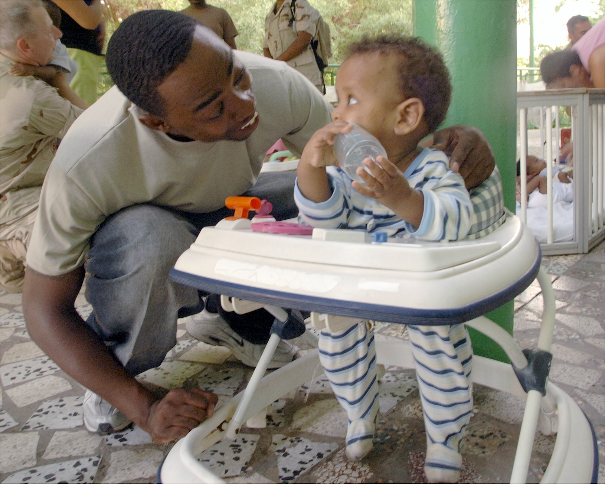 Staff Sgt. Adrian Mask plays with an orphaned toddler at the Franciscan Missionaries of Notre Dame Baby Orphanage in Djibouti City, Djibouti. Sergeant Mask is an air traffic control liaison for N-3 Navy Operations and is deployed to Camp Lemonier, Djibouti, from the 49th Operations Support Squadron at Holloman Air Force Base, N.M. Sergeant Mask volunteers as often as his schedule allows to help feed and play with 40 orphaned children. (U.S. Air Force photo/Staff Sgt. Francesca Popp) 
