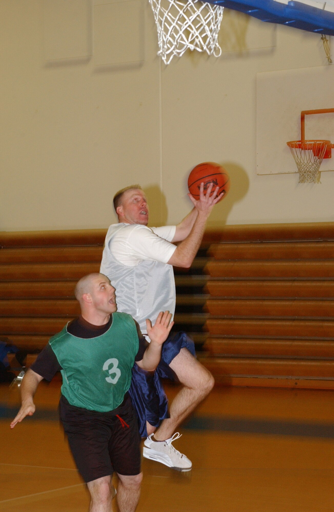 MCCHORD AIR FORCE BASE, Wash.-- 
Kristopher Auger, 62nd Medical Group, goes in for a lay up over Joel Pfaff, 1st Air Support Operations Group.
(U.S. Air Force photo/Tyler Hemstreet)