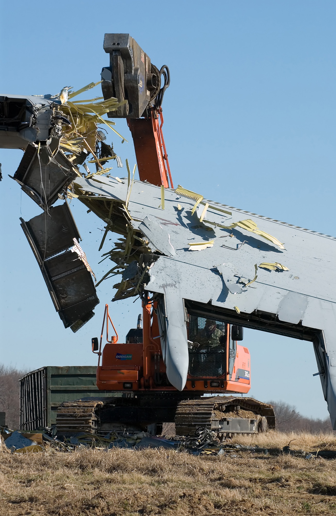 DOVER AIR FORCE BASE, Del. -- A contractor removes portions from the April 3, 2006 C-5 mishap aircraft here this week. The contractor began by stripping the interior of the plane of all waste and contaminants. They then cut the wings off the plane Jan. 24 with a set of giant mobile shears. The contractor estimated it will take 10 days to completely remove the plane. (U.S. Air Force photo/Roland Balik)