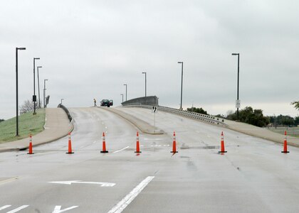 An ice-slick Truemper Street bridge over Military Drive on Lackland Air Force Base, Texas, is blocked off with cones in this view looking east Jan. 17, 2007. Road conditions such as these existed all across the San Antonio area, resulting in the base closure for all but essential personnel Jan. 16 and 17. "Safety for Team Lackland was paramount in making the decision to close the base," said Brig. Gen. Darrell Jones, then the 37th Training Wing commander. "We have a lot of dedicated people on this base who wanted to come to work, but I'd rather have them home for a day or two, waiting out the weather, than risk being in an accident." (USAF photo by Alan Boedeker)                              