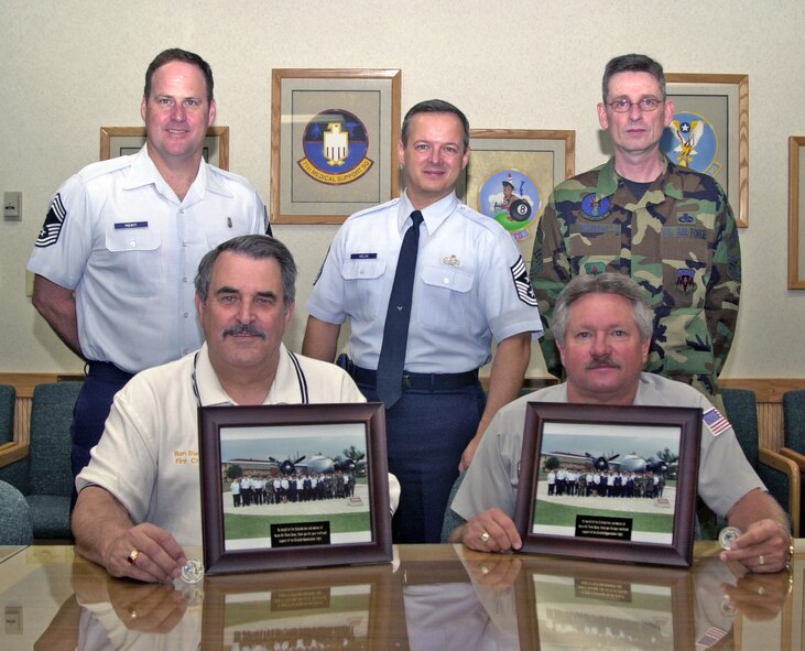 (Photo by Frank McIntyre) Ron Diener and Rich Johndrow (seated) were presented the inaugural Vance AFB Chiefs Group Outstanding Performance Awards by (standing from left) CMSgt Ron Prewitt, 71st Medical Group, Command Chief Jeff Kallas and CMSgt Matt McNally, 71st Communications Squadron.