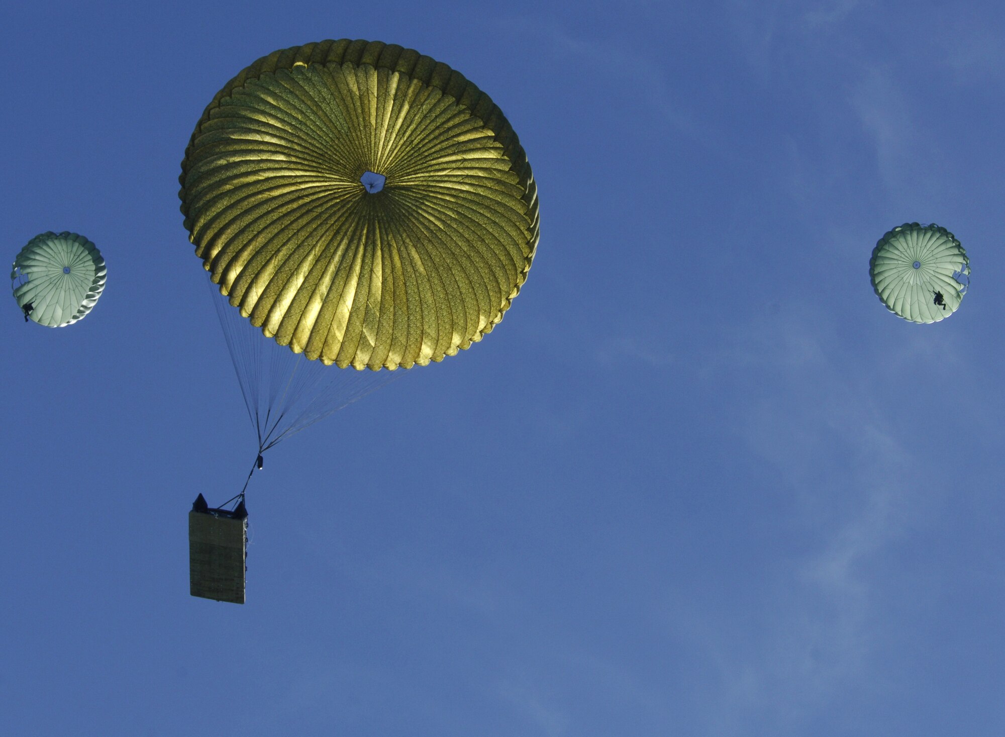 Pararescuemen and a fully-inflated zodiac raft parachute down to the ‘Shark Water’ drop zone during a recent three-day exercise at Key West Naval Air Station, Fla. During the trip, the 71st and 38th Rescue Squadrons combined efforts to test two life-saving capabilities; the Hard Duck and Advanced Rescue Craft processes. (U.S. Air Force photo by Senior Airman Javier Cruz)