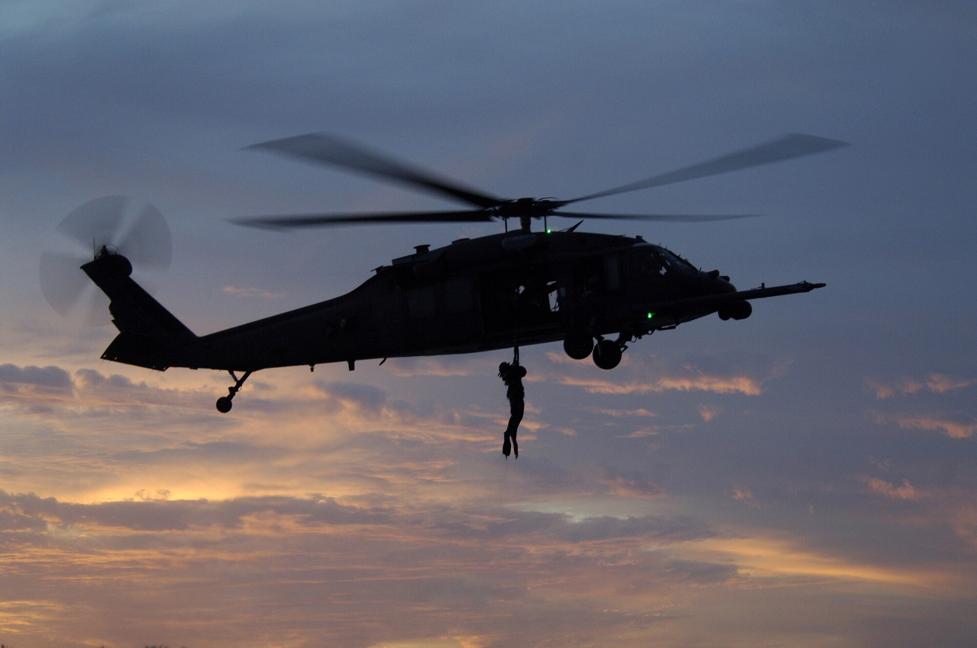 A 38th Rescue Squadron pararescueman rappels from an HH-60G Pave Hawk helicopter during a three-day training exercise at Key West Naval Air Station, Fla. All three Moody rescue squadrons tested new capabilities while participating in an interservice exercise with the U.S. Army. (U.S. Air Force photo by Senior Airman Javier Cruz)