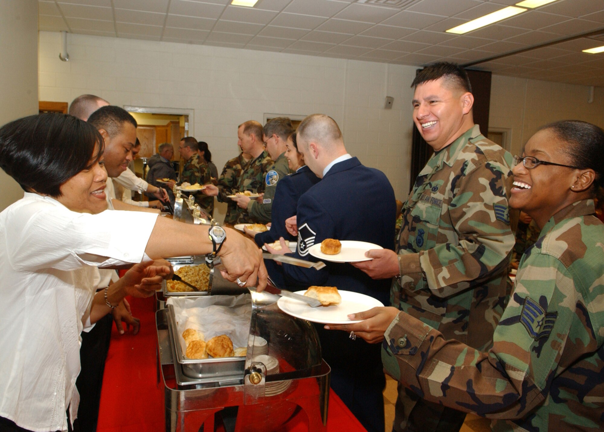 Airman from Cannon Air Force Base, N.M. enjoy breakfast at the base chapel Jan. 12 in celebration of the life of Martin Luther King Jr. The Reverand Maurice Monson addressed the audience following the presentaiton of the colors by the Cannon Honor Guard, the singing of the National Anthem by Mrs. Jacqueline Pinkett-Smith and a hymnal sung by Oscar "O.C." Clear. (Photo by Airman Erik Cardenas)                           