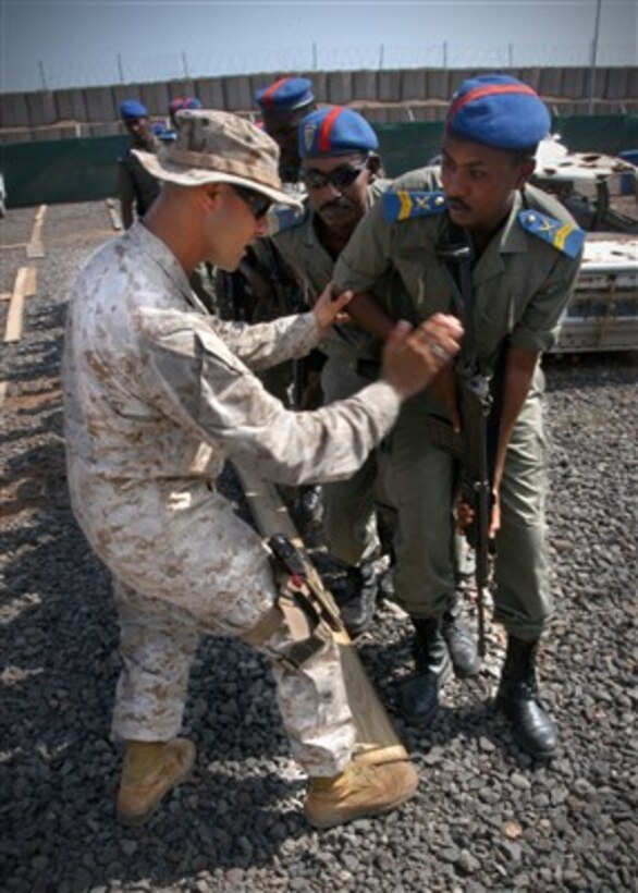 U.S. Marine Corps Sgt. Jeremy Gutierrez directs students from the Djiboutian National Police during training on basic weapons procedures and room clearing at Camp Lemonier, Djibouti, on Dec. 21, 2006.  Gutierrez is assigned to the 5th Provisional Security Company.  