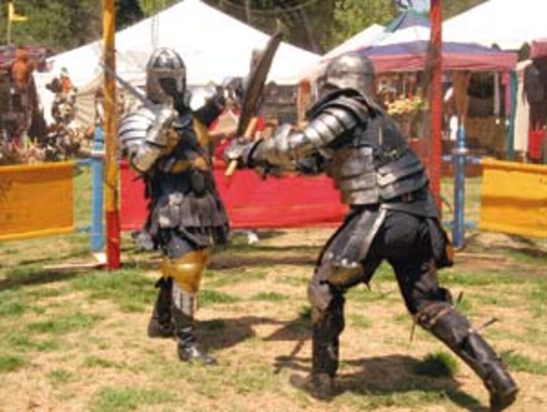 Captain Storm (left) of The Black Company blocks an axe blow delivered by Matt Vanderploes during a tournament  at the Renaissance Fair. The Black Company is one of more than 40 roleplaying clubs or 'guilds' that made up the atmosphere of the fair.