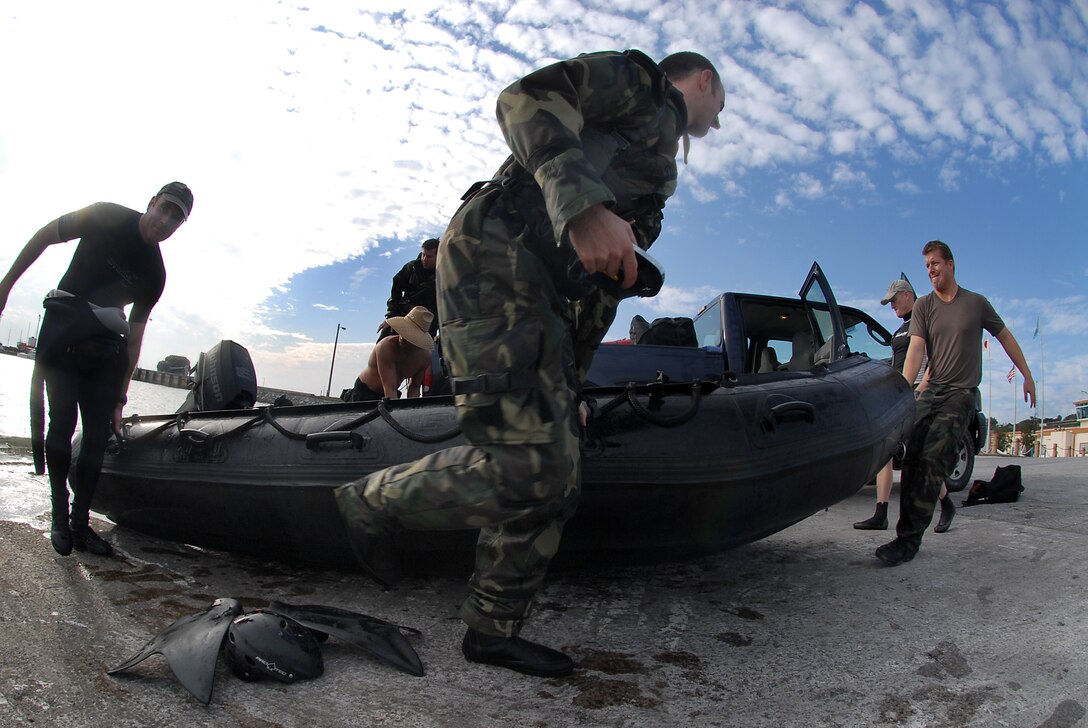 Pararescuemen from the 31st Rescue Squadron on Kadena Air Base, Japan, carry a F470 Zodiac boat from the water used to pick up fellow pararescuemen Jan. 16.  (U.S. Air Force photo/Airman 1st Class Kelly Timney)