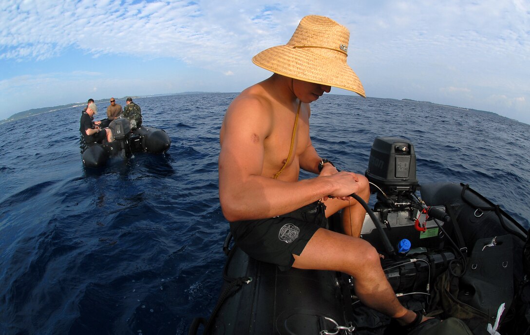 Senior Airman Jonathan Courtright, 31st Rescue Squadron, Kadena Air Base, Japan, gets ready to start the F470 Zodiac boat for a 3-mile boat ride back to the dock at the White Beach Naval facility after participating in a weekly training exercise Jan. 16.  (U.S. Air Force photo/Airman 1st Class Kelly Timney)