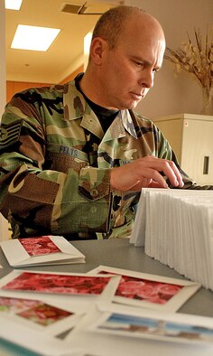 Tech. Sgt. Steve Felts, noncommissioned officer in charge of the Airman and Family Readiness Center, arranges Valentine?s Day cards for deployed servicemembers.  U.S. Air Force photo by Todd Berenger
