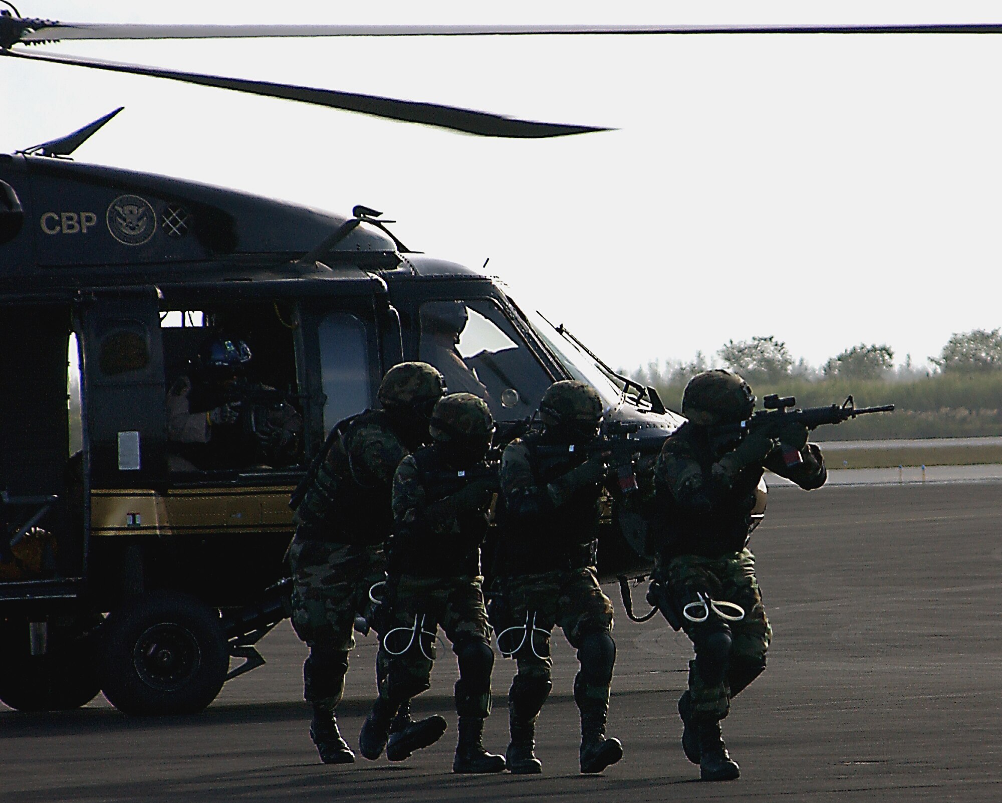 Members of the Homestead Air Reserve Base Special Response Team approach a diverted airplane after an aerial insertion by US Customs during a training exercise here at Homestead ARB, Fla. Once SRT members are trained, they are on-call 24 hours a day. (U.S. Air Force photo/Dan Galindo)