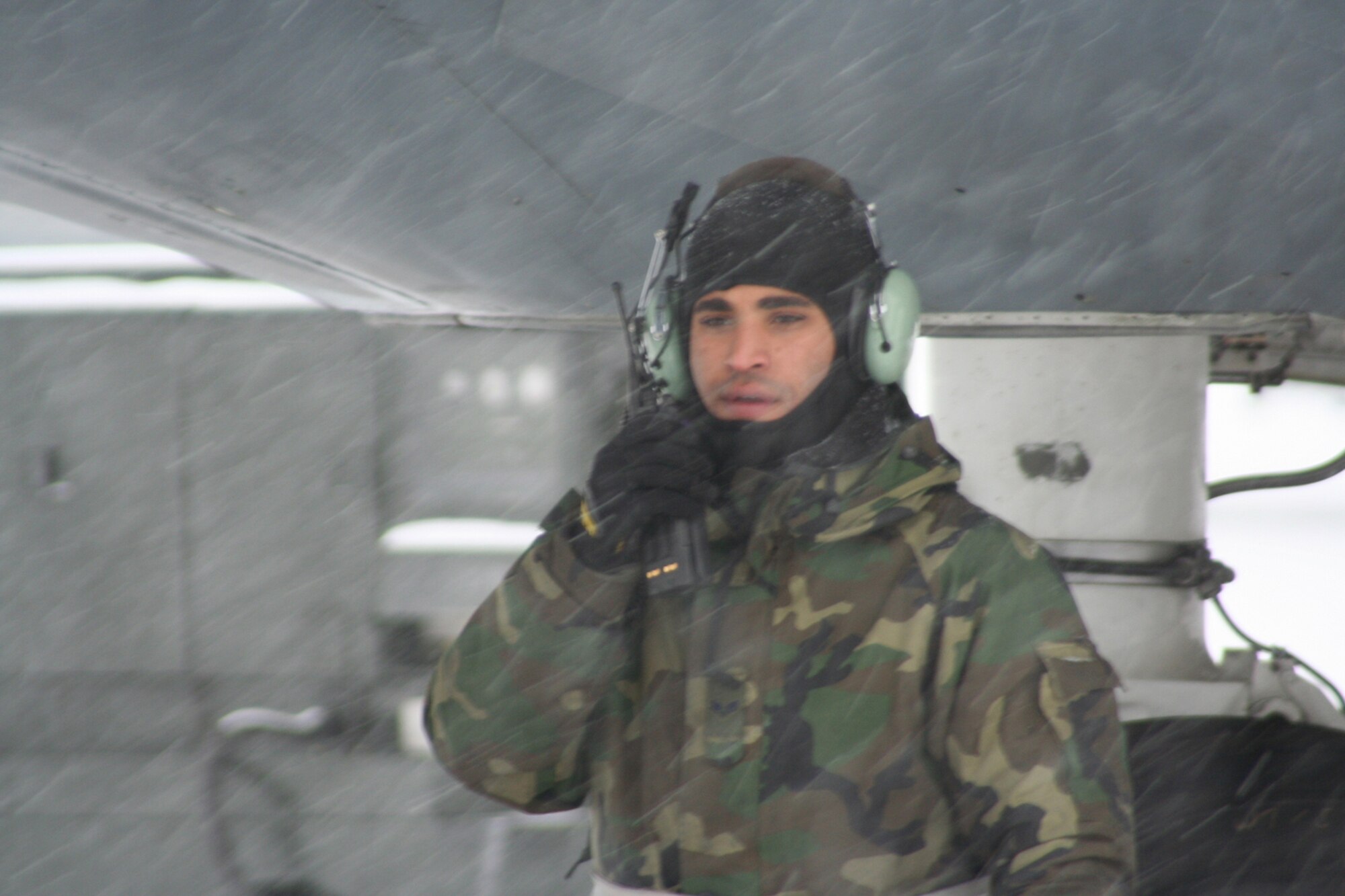 WRIGHT-PATTERSON AFB, Ohio -- Senior Airman Alvin Smith, Air Force reservist from the 445th Maintenance Squadron, radios the flight engineer on the flightdeck of the C-5 before adding power to the cold snow covered C-5 aircraft.  (U.S. Air Force photo/MSgt. Doug Moore)