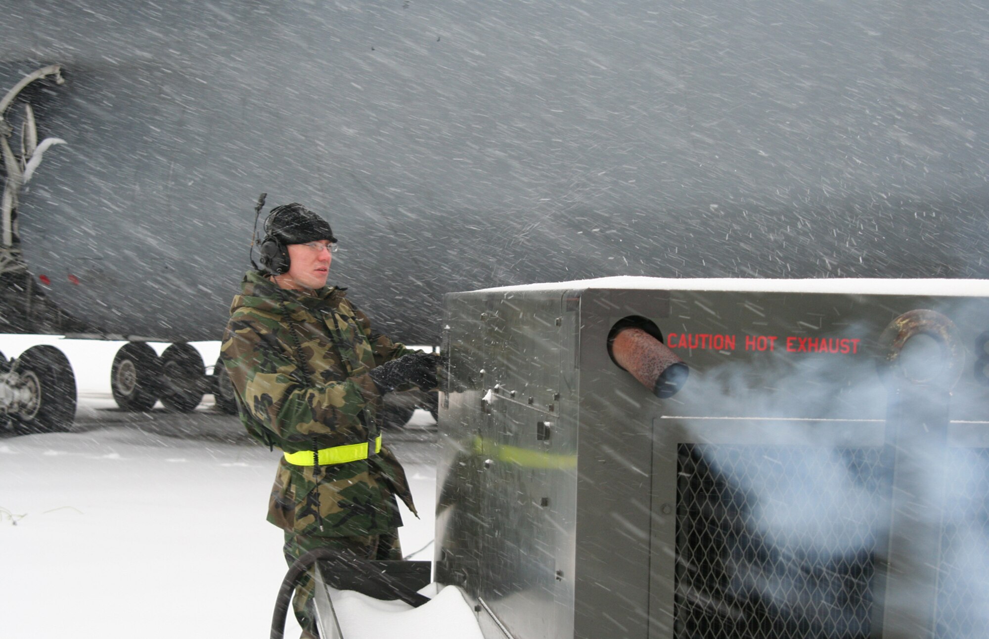 WRIGHT-PATTERSON AFB, Ohio -- Air Force reservist Senior Airman John Walker starts up the auxiliary power unit to supply power to a snow covered C-5 aircraft. Harsh winter weather blanketed the base with approximately three inches of snow.  (U.S. Air Force photo/MSgt. Doug Moore)