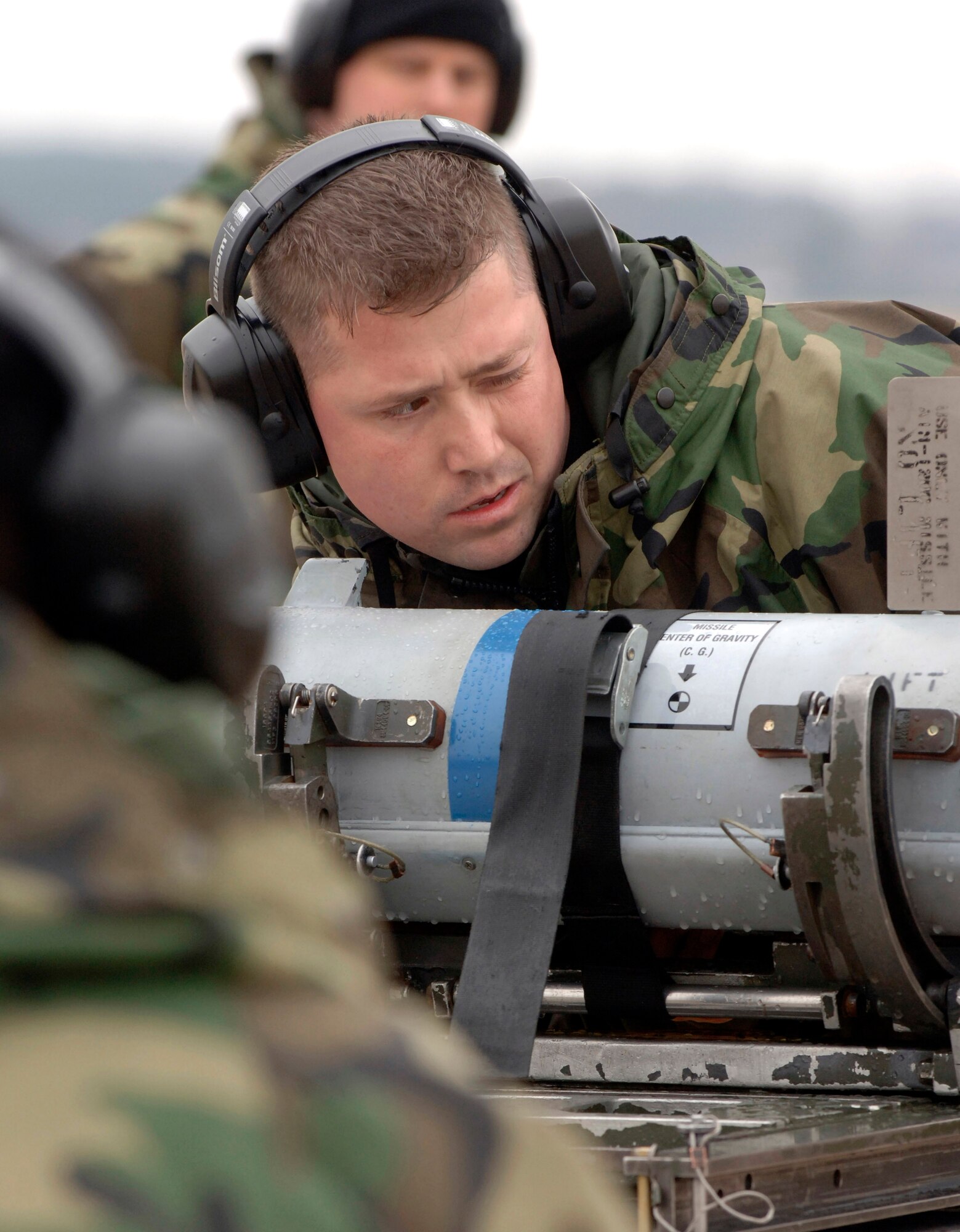 Staff Sgt. Kevin Pendleton examines ammunition before loading it onto an F-15 Eagle Jan. 18 during the Load Competition of the Year at Langley Air Force Base, Va. The competition evaluates technical proficiency, safety procedures and overall time. Sergeant Pendleton is part of a three-member team from the 71st Fighter Squadron. (U.S. Air Force photo/Airman 1st Class Vernon Young) 
