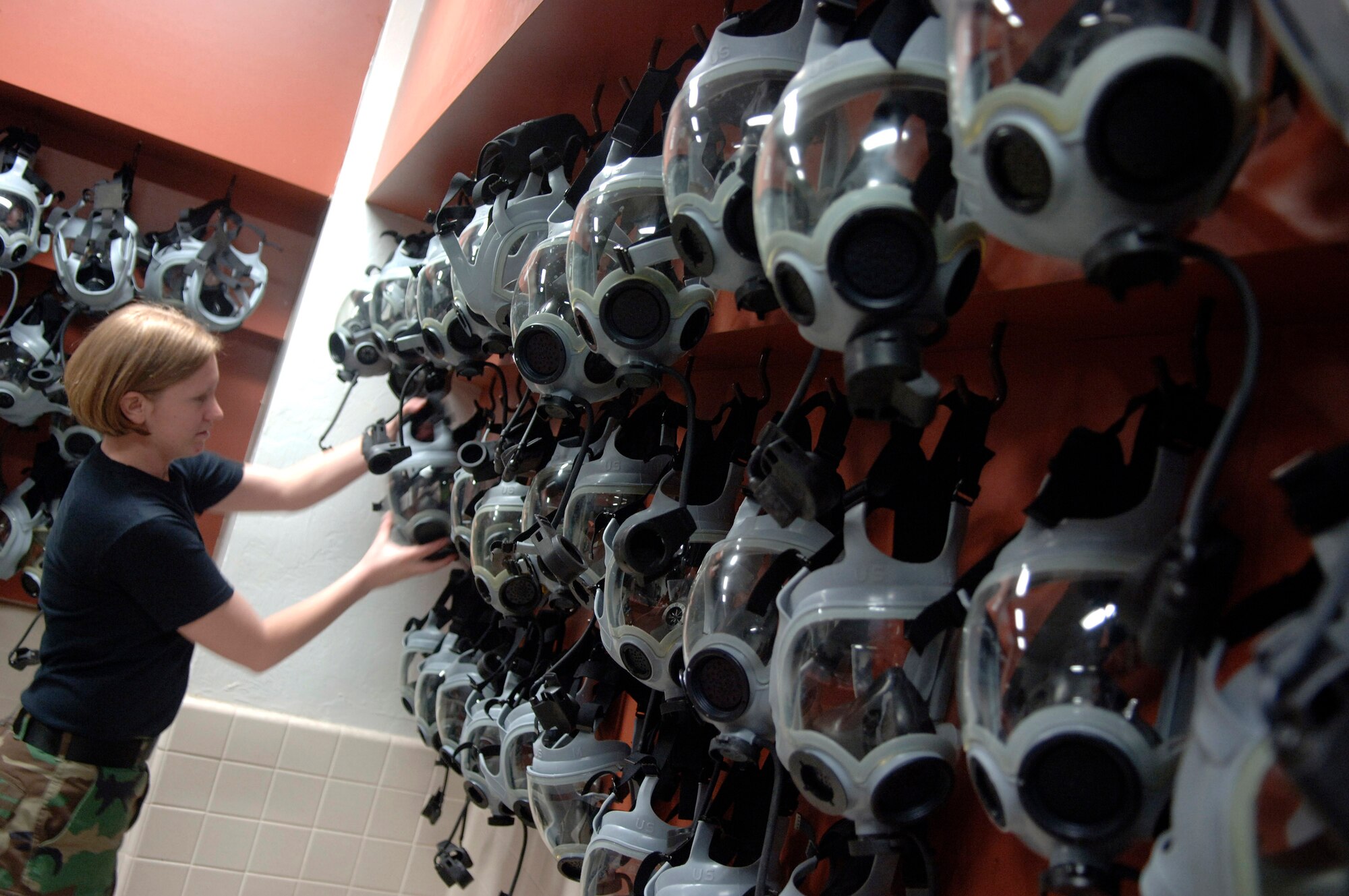Airman Stephanie Walton hangs up gas masks to dry Jan. 20 during Phase 1 of Exercise Bushwacker 07-02 at Davis-Monthan Air Force Base, Ariz. Bushwacker 07-02 is an operational readiness exercise that tests the wing's deployment abilities. Airman Walton is assigned to the 355th Logistics Readiness Squadron. (U.S. Air Force photo/Senior Airman Jesse Shipps)
