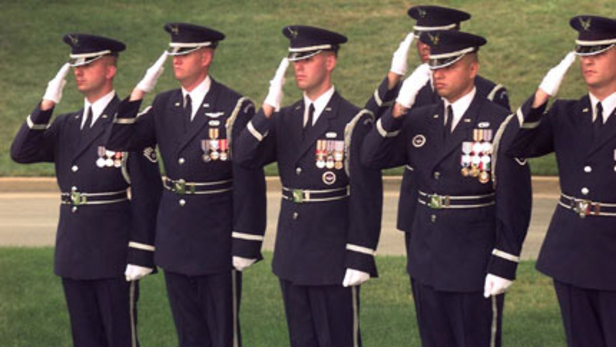 MISAWA AB, Japan -- (from left to right) Staff Sgts. Peter Patrick, Timothy Carney, David Busby, Ruben Gonzales, Anthony Thomas salute as the colors pass during the Air Force honor guard change of command ceremony on June 28, 1999.