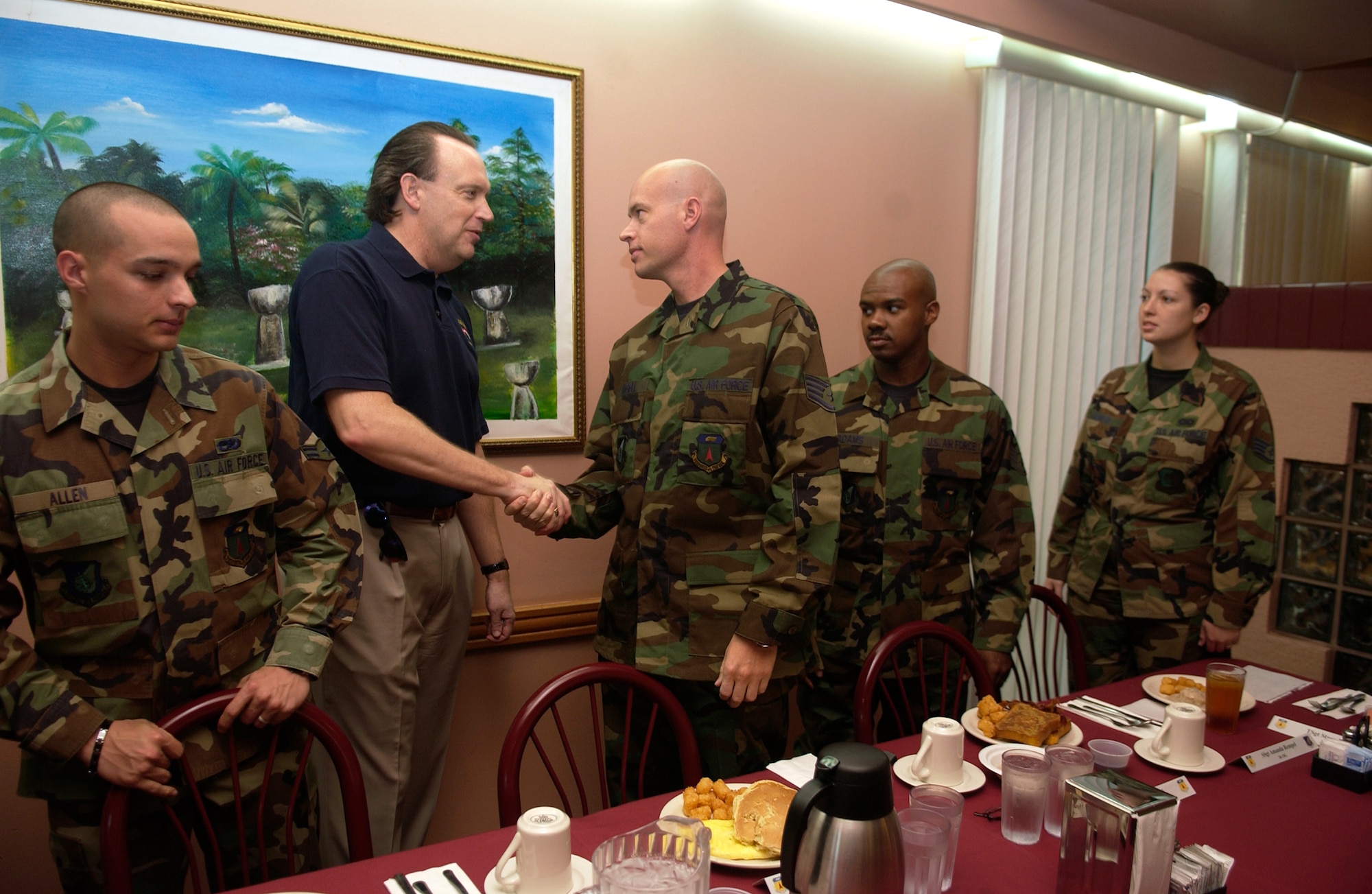 William C. Anderson shares breakfast with several Airmen Jan. 20 during his visit to Andersen Air Force Base, Guam. As assistant secretary of the Air Force, Mr. Anderson heads three division departments that deal at the policy level with Air Force facility and logistical issues. The department's responsibilities include installations, military construction, base closure and realignment; environment, safety and occupational health issues; and all logistical matters. (U.S. Air Force photo/Senior Airman Miranda Moorer)