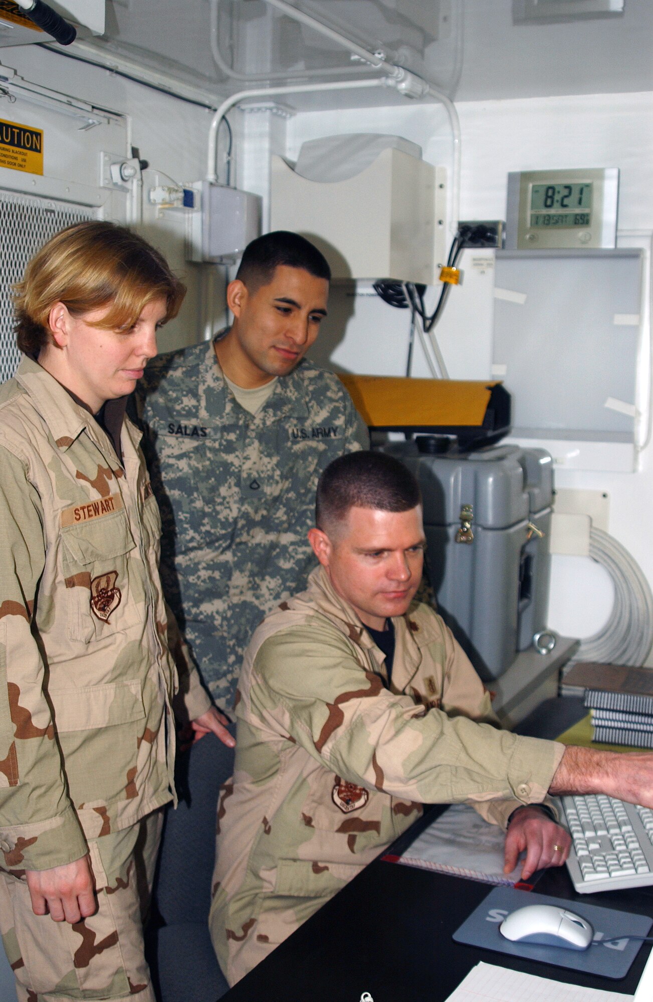 Senior Airman Julie Stewart, (from left) Army Pfc. Daniel Salas, and Maj. Robert Jesinger review an X-ray at the Air Force Theater Hospital at Balad Air Base, Iraq. Airman Steward is a 332nd Expeditionary Medical Group radiology technologist, and Major Jesinger is the 332nd EMDG radiology flight commander, both deployed from Travis Air Force Base, Calif. Private Salas is a 53rd head and neck team radiology technologist deployed from Fort Lewis, Wash. (U.S. Air Force photo/Staff Sgt. Alice Moore) 
